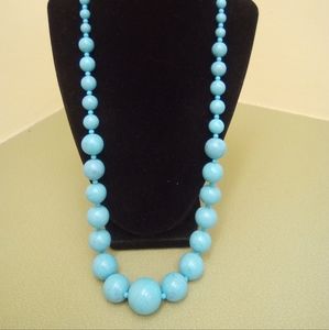 Baby blue beaded necklace with a splash of black large and small beads adjustabl